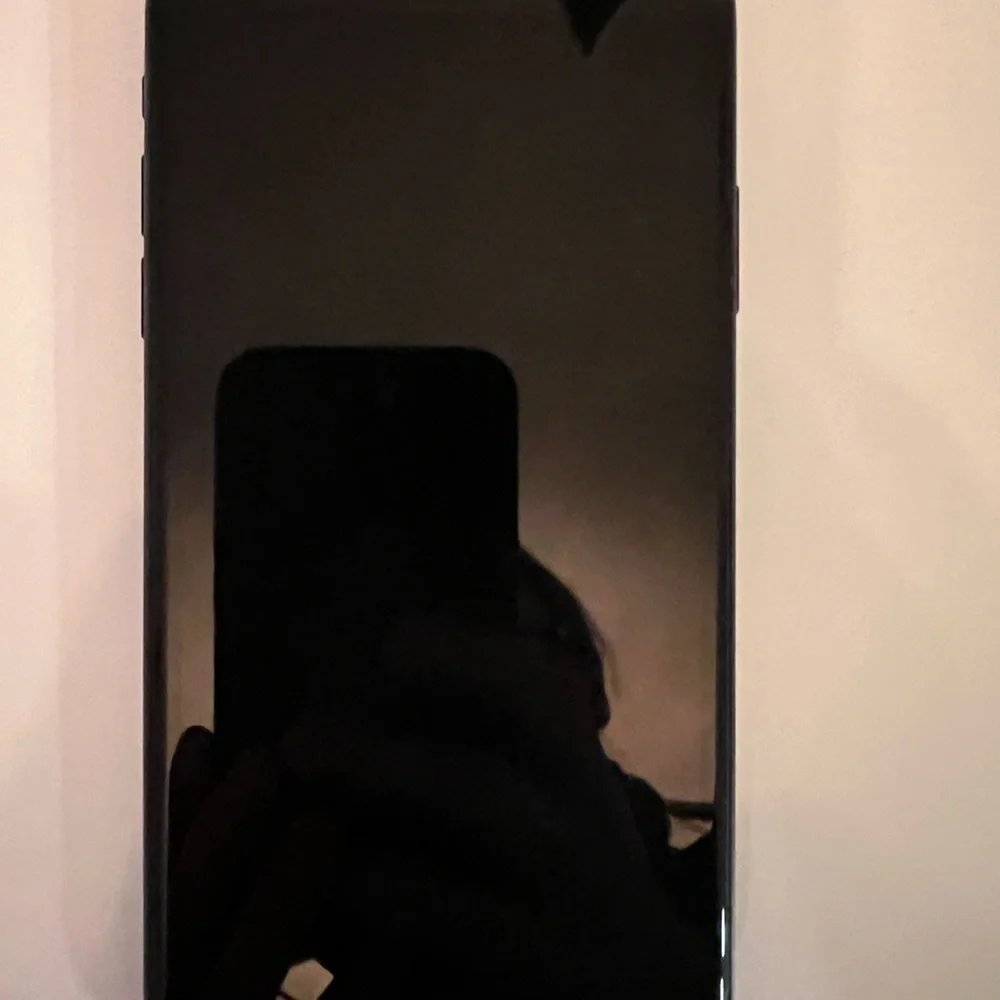 Apple Black XR - 128 GB, unlocked phone with two cases.